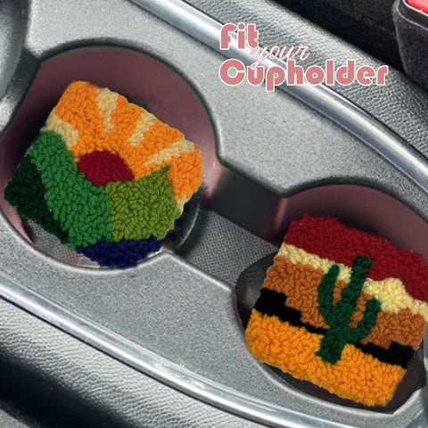 Two colorful punch needle coasters with landscape patterns in car cupholders. Easy To Use Punch Needle Coaster Kit For Beginners.