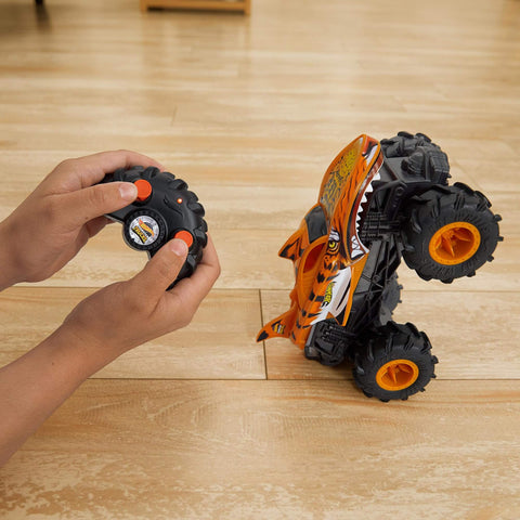 Monster Trucks RC Tiger Shark One Twenty Four Scale Remote Control Truck With Terrain Action Tires in use on wood floor