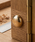16 Pieces Brass Capped Fixing Screws With Curved Decorative Head Caps For Mirrors And Furniture Golden Color Sturdy Integrated Design Built For Quick Woodworking Fixes And Easy Furniture Repair Projects on a wooden surface next to a ruler and shavings