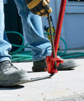Manual steel rebar bending with the Marshalltown Qlt Manual Rebar Bender on concrete, showcasing 34-inch tool in use.