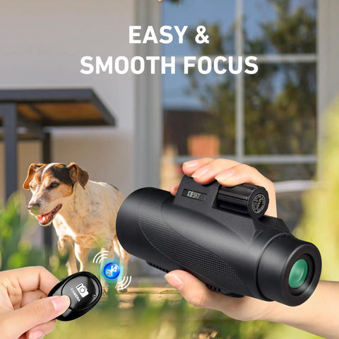 Image showing a hand holding 15x52 HD Monocular With Tripod For Hunting, Bird Watching, Hiking, And Travel, with Bluetooth camera remote.