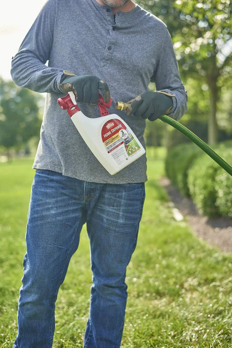 Person holding Ready To Spray Outdoor Insect Killer With Hose End Sprayer For Lawn And Landscape, kills ants ticks mosquitoes