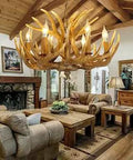 Rustic Resin Antler Chandelier With 6 Lights hanging in a cozy living room with wooden beams, brown antler-like branches.