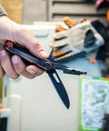 Person holding 8 In 1 EDC Multitool Pocket Knife with Blade Pry Bar Hammer Saw Bottle Opener, burnt orange, for camping.