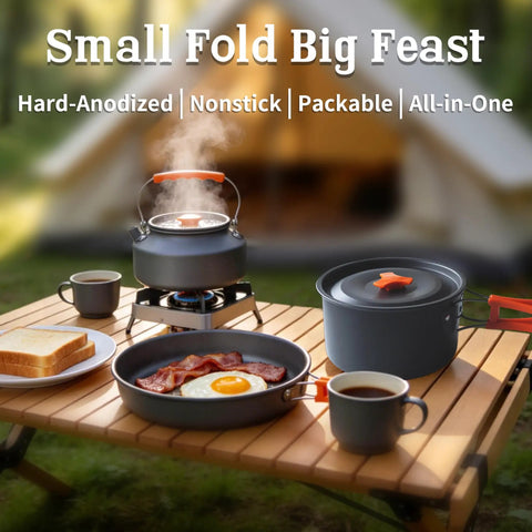 Collapsible Camping Cookware Set With Nonstick Pots, Pans, And Kettle For 2-4 People on a table, open-fire ready.