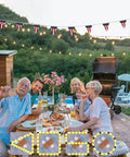 4 Pack Outdoor String Light Poles 10.5 Ft Tall With Screw In Dirt Insertion Over 20 Inches set up at backyard family dinner