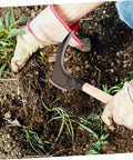 Person using Lightweight Manganese Steel Garden Weeding Tool With Portable Double Edged Sickle for easy weeding.