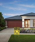 Slow Down Kids And Pets At Play Sign 2 Pack with metal stakes in residential driveway