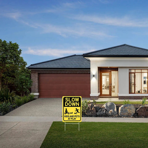 Slow Down Kids And Pets At Play Sign 2 Pack with metal stakes in residential driveway