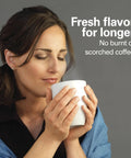Woman enjoying coffee brewed with One Press Programmable Dispensing Drip Coffee Maker With Internal 12 Cup Brew Pot And Water Reservoir