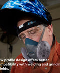 Worker wearing small size half facepiece reusable respirator with NIOSH approval and cool flow valve, silicone faceseal for tight fit