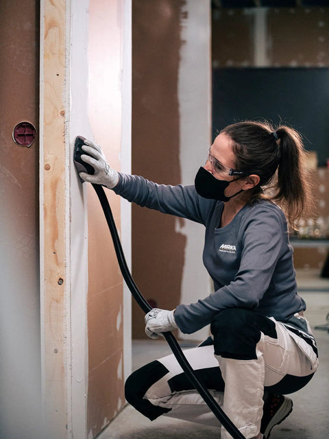 Person sanding wall with Vacuum Hose For Hand Sanding Blocks 13 Ft Lightweight Flexible Hose With Tapered Plug Fits Multiple Vacuum Ports And Industrial Vacuums 915 L Class 1025 L Class 1230 1242 Hand Block Compatibility Push Fit Connection.