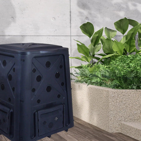 Outdoor Compost Bin With Lift Off Lid 65 Gallon Capacity Four Door Access And Vent Holes next to garden plants
