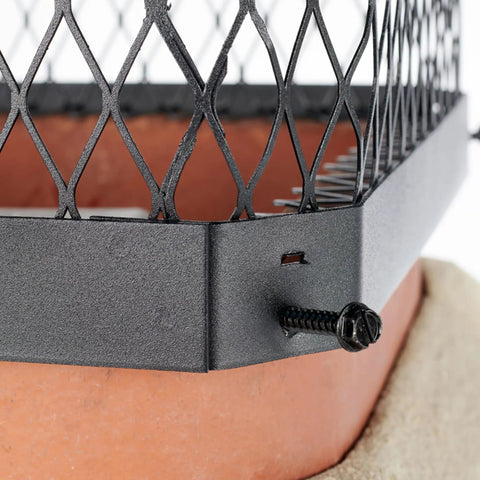 Close-up of All Weather Galvanized Steel Chimney Cover With Bolt On Install Black Chimney Cap on clay flue tile