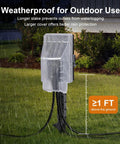 Outdoor Dusk To Dawn Stake Timer Power Hub with Six Outlets, Weatherproof Power Strip, elevated with rain cover in garden