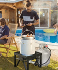 Dual Burner Propane Camping Stove With 200,000 BTU Beast Power in use by a poolside for outdoor gathering