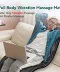 Person relaxing on a sofa using Full Body Massage Pad For Bed With 10 Vibration Motors And 5 Massage Modes, Heated Mattress Pad For Back And Whole Body, Auto Shut Off, Chill Out Comfort Gift For Men And Women.
