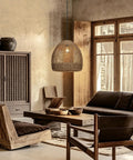 WALMHEIM 15.7" Boho Rattan Pendant Light Fixture hanging in a rustic living room with wooden furniture.