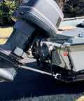 Side view of boat with Adjustable Transom Saver From 23 To 35 Inches For Boat Motor Support installed, showing engine stability on trailer.