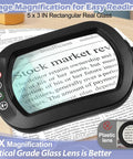 Close-up of 10X Rectangular Glass Magnifier Lamp With Light and Stand for easy reading, showing magnified text on page.