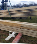 Heavy Duty Furniture Lifter That Makes Moving Day A Complete Piece Of Cake Without Making You Break A Sweat For Easily Hoisting Doors Windows And Drywall Panels With Non Slip Traction beside stacked wooden beams.