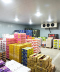 Inside view of Shop Grade Modular Walk In Cooler And Freezer Combo For Restaurant Food Storage Quick Snap Together Insulated Cold Room Kit with stacked boxes.