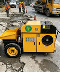 Compact Mini Concrete Pump Trailer For Shootin Smooth Mortar And Material Delivery in action on a job site.