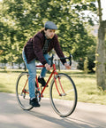 Cyclist riding a red road bike, illustrating the Heavy Duty 700C Bike Inner Tubes 700x35C To 43C With 60mm Presta Valve, Reliable Replacement Tubes