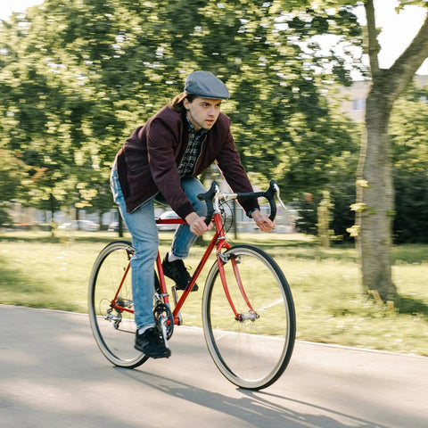 Cyclist riding a red road bike, illustrating the Heavy Duty 700C Bike Inner Tubes 700x35C To 43C With 60mm Presta Valve, Reliable Replacement Tubes