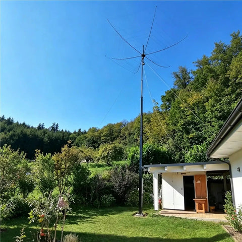 Top Tier Rock Solid 6 Meter Aluminum Telescopic Mast With No Sweat Manual Winch Crank Tripod Stand For Broadcast Lighting And Outdoor Antenna Deployment in a garden.
