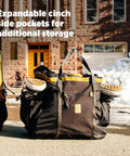 Monster 48L Gear Hauler Tote Bag In Recycled Nylon with ski boots in side pockets on snowy street.