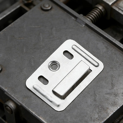 Close-up of a stainless steel wall panel clip for drywall repairs, showcasing rust-resistant interlocking buckle design.