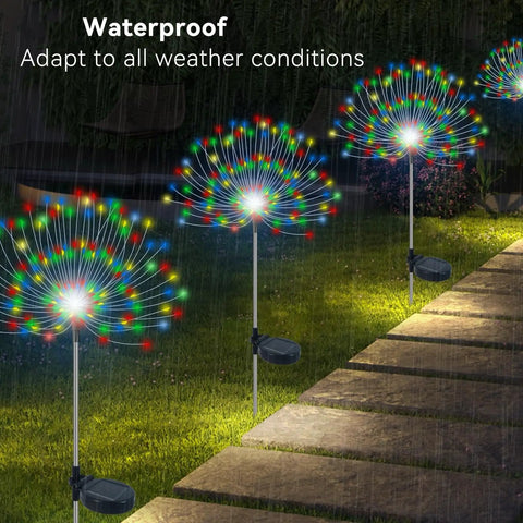 Outdoor Solar Firework Lights 120 LED 2 Pack Waterproof Garden Decor Multicolor Colorful Pathway And Flowerbed Lighting For Your Yard Parties Christmas And Holiday Decor lighting up a garden path at night in rain.