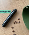 Compact Coffee Knock Box 4.6 Inch Barista Style Espresso Grounds Holder With Removable Plastic Knock Rod Non Slip Base Green Espresso Maker Accessory For Home Office And Cafe Use shown with knock rod and coffee beans