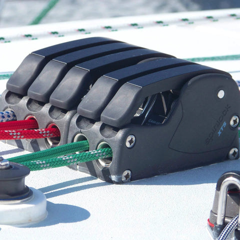 Spinlock XTS rope clutch, single alloy deck hardware, side view with red and green lines.