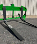 No Hassle Dual Mount Tractor Pallet Forks For Front Loader And Three Point Hitch showing heavy-duty black forks and bright green frame.