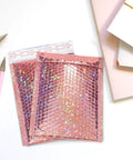 Rose Gold Holographic Bubble Mailers Bulk Pack Of 30 Self Sealing Padded Envelopes 11 By 7 Inches displayed on desk