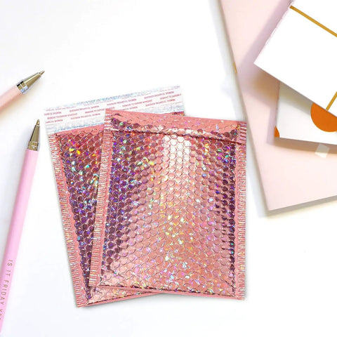 Rose Gold Holographic Bubble Mailers Bulk Pack Of 30 Self Sealing Padded Envelopes 11 By 7 Inches displayed on desk