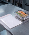 30 Pack 6 By 8 Inch Bubble Mailers Self Seal Envelopes Waterproof Protective Mailing Bags next to food container on metal table