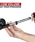 Hands holding Portable Bike Fork And Rear Shock Pump 400 PSI With 1.5 Inch Gauge Micro Air Adjust Button Swivel Hose compact size.