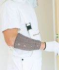 Heavy Duty Cut Resistant Wrist Sleeves Built Tough With Reinforced Denim For Industrial Steel Handling Abrasion Proof Forearm Guards That Kick Ass At Work Sites (1 Pair) worn by a worker measuring.