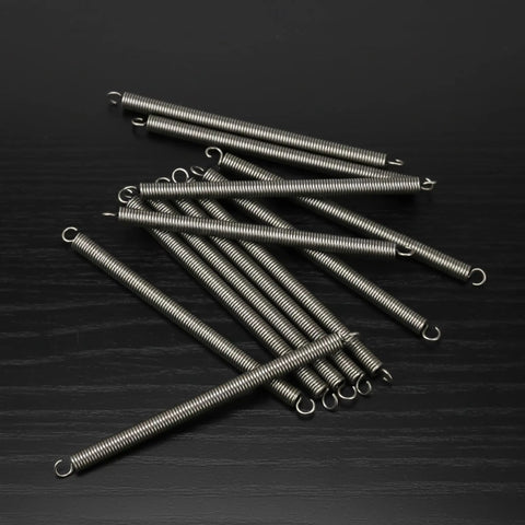 OTF Knife Spring Replacement Kit 12 Steel 304 Springs For Ultratech UT Series Knives laid out on black surface