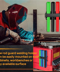 Welding rod holder mounted with colored rods, welder wearing red helmet in action, sparks flying