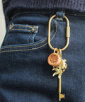 Ten Piece Solid Gold Brass Key Rings Set With Locking Carabiner Clips attached to jeans showcasing purse bag charm holder