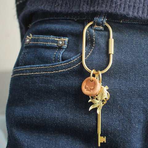 Ten Piece Solid Gold Brass Key Rings Set With Locking Carabiner Clips attached to jeans showcasing purse bag charm holder