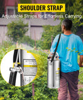 Person carrying 2-Gallon Stainless Steel Hand Pump Sprayer With 20-Inch Wand And 3-Foot Reinforced Hose in garden, showing shoulder strap.