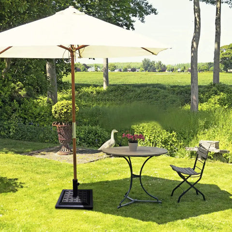 Garden view with a Beefed Up 30Lb Patio Market Umbrella Base With Cast Iron Tube Holder supporting an umbrella near a table.