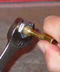 Using Pro Grade 20-Piece Spindle Thread Restorer Die Set on vehicle spindle with wrench