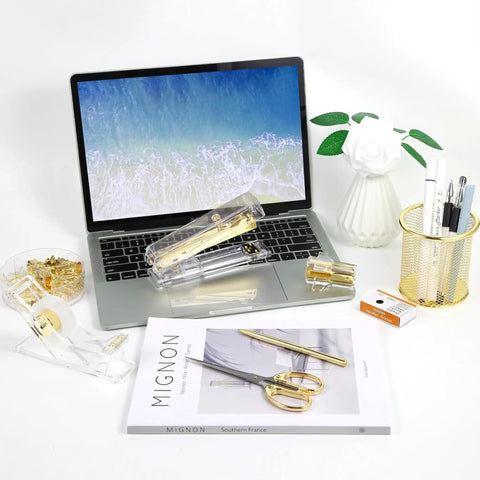 Shiny Gold Tone Office Desk Accessories Set With Acrylic Stapler Tape Dispenser Ballpoint Pen on desk with laptop