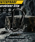 Heavy Duty Black Carabiner Clip Built Tough For 900lbs, 3 Inch Steel D Shaped Snap Hook on rock with water splash